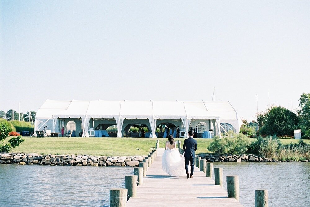 herrington-on-the-bay-wedding-venue-in-maryland-asian-american-ceremony-christian-blue-bridesmaids-dresses-floral-waterfront-beach-front-ceremony-first-look-on-pier-white-tent-hanging-greenery-reception-details-9.jpg