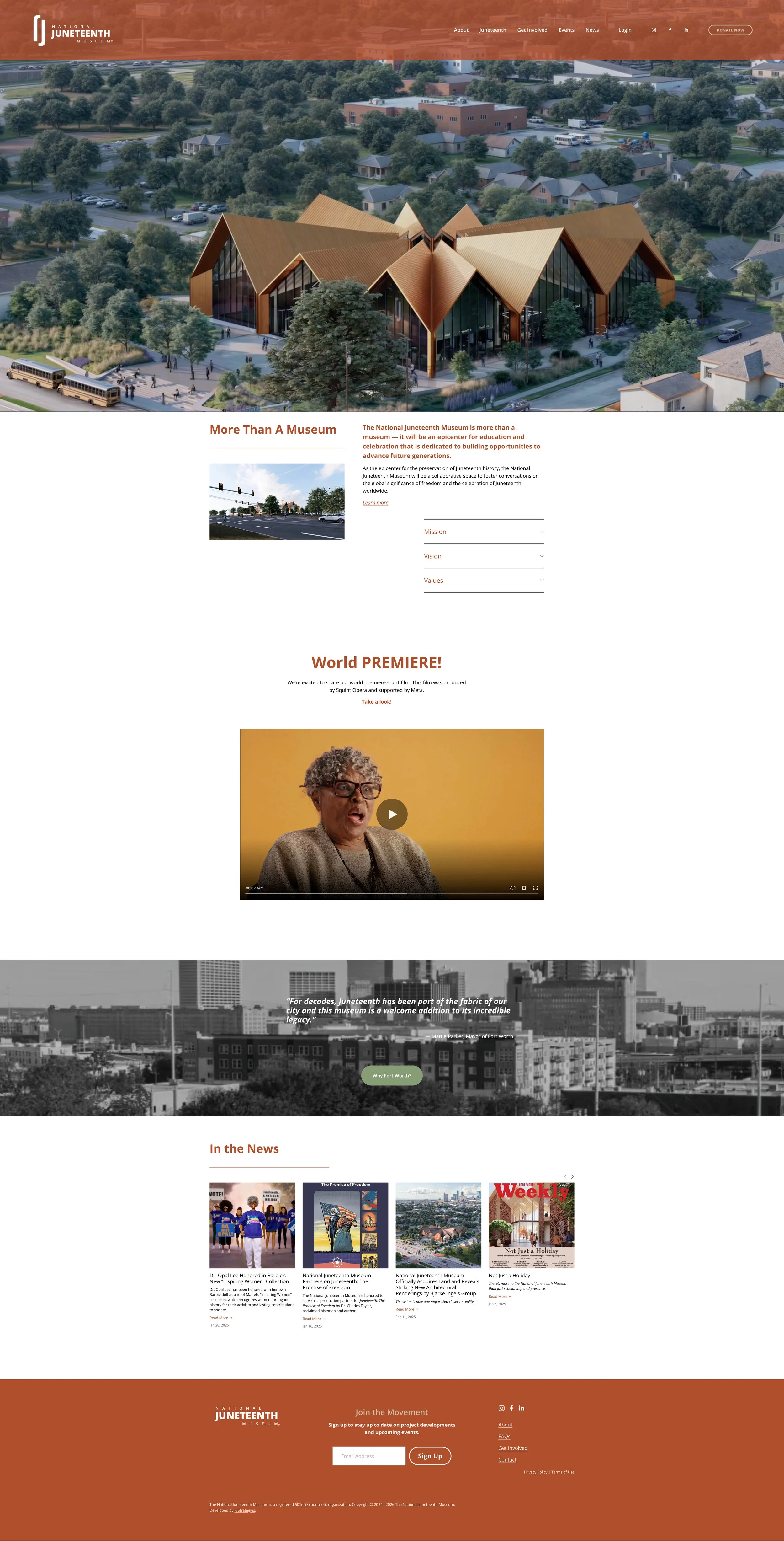 Aerial view of the National Juneteenth Museum building with a unique geometric roof design, surrounded by trees and nearby residential neighborhood.