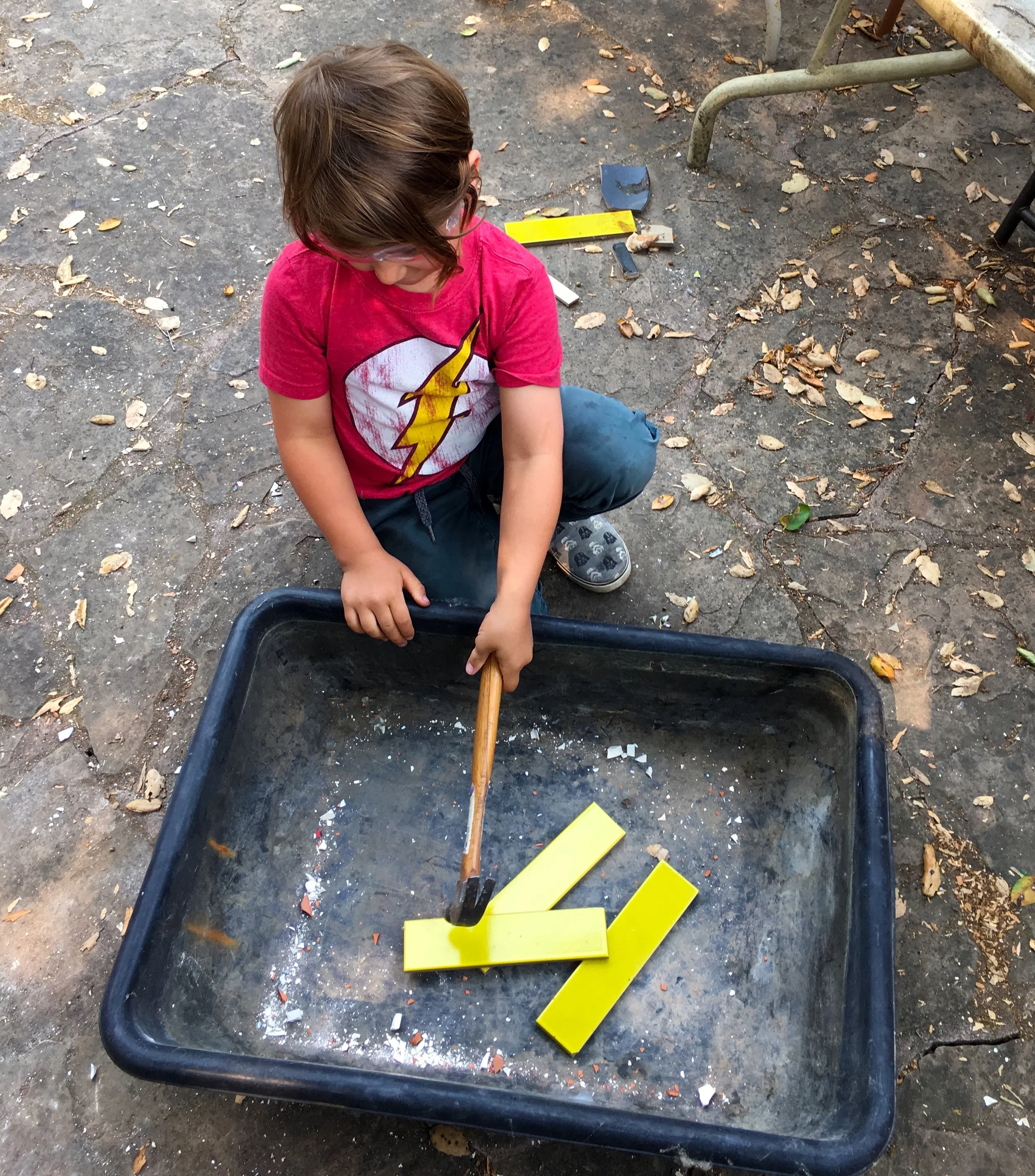 Napa native, Ila Pearl, smashing some beautiful yellow tile seconds, donated to the project by Heath Ceramics 