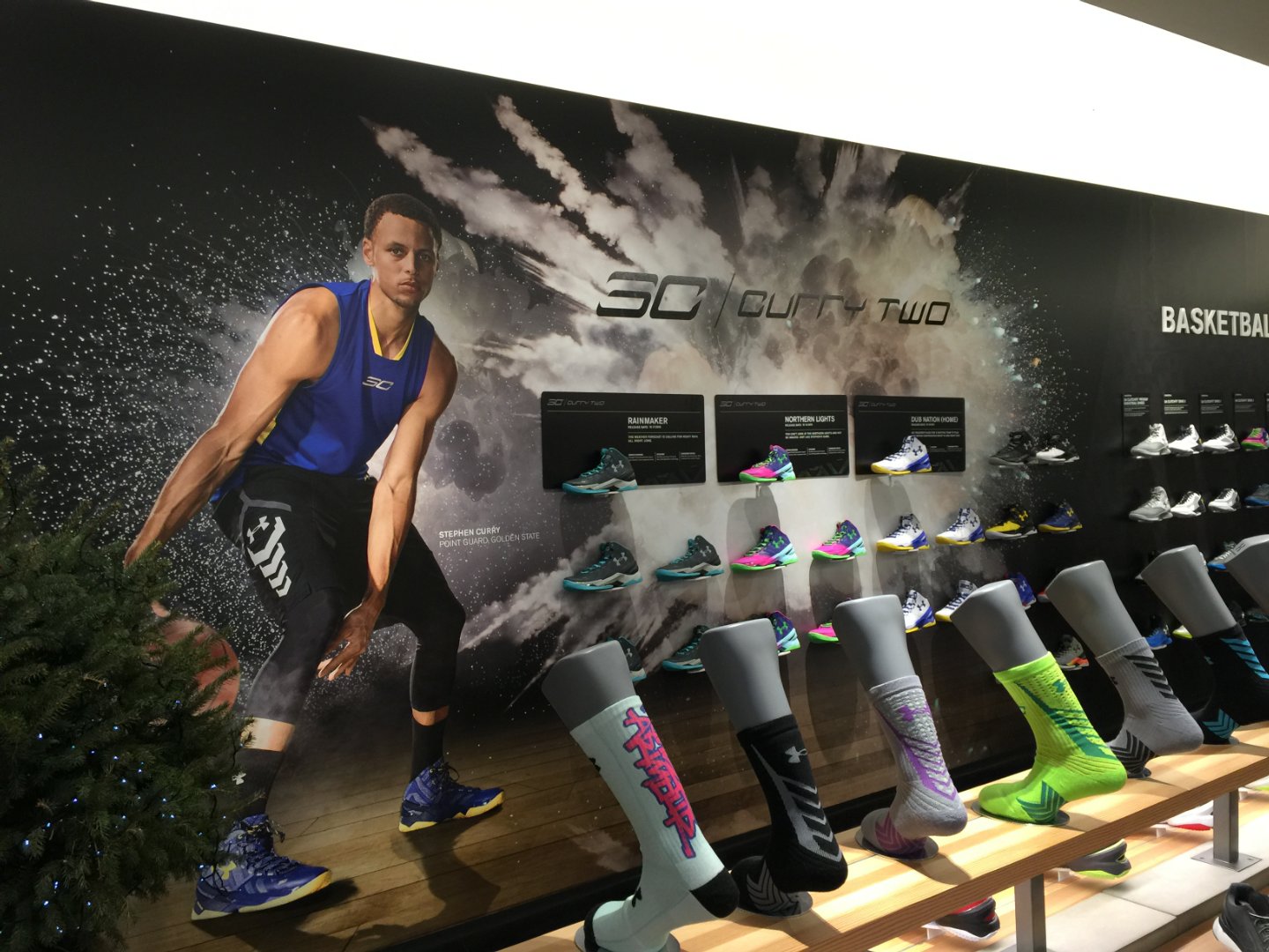 The Steph Curry shoe display wall, showcasing his "Curry Two" basketball shoes in various colorways.