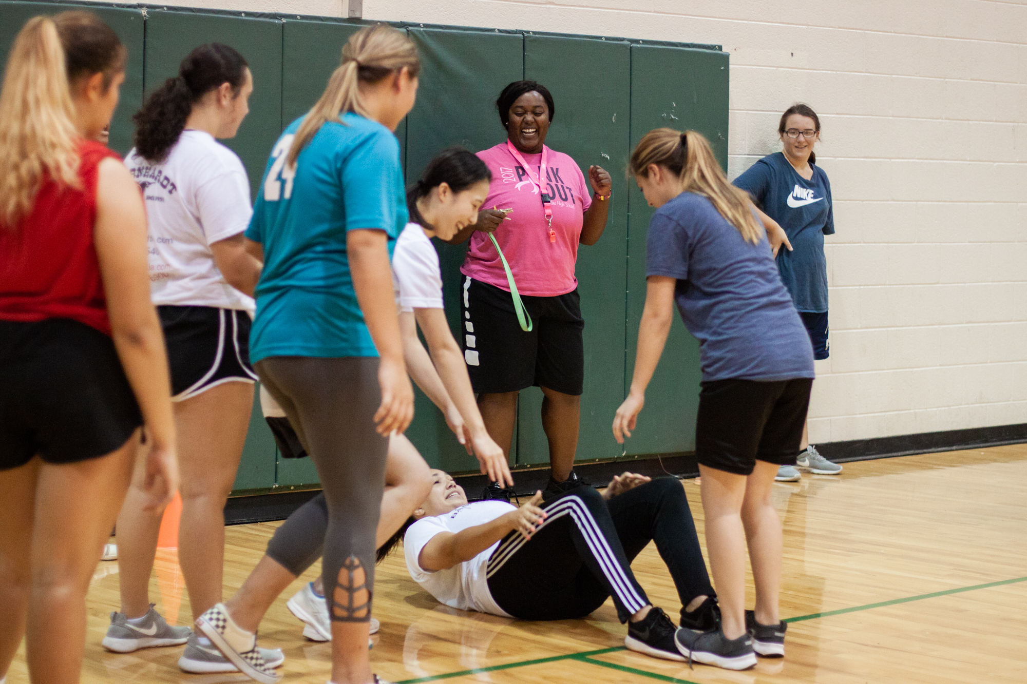  Chiniqua Bright laughs as her students help each other perform sit-ups on Oct. 3, 2018. Bright and her students were warming up for the 2018 basketball season to begin.  