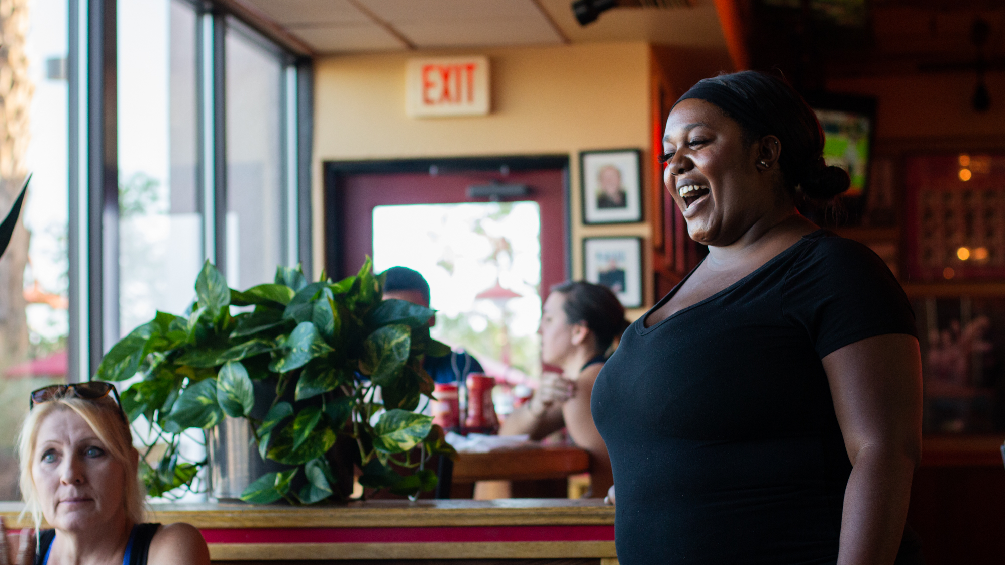  Chiniqua Bright laughs with a customer at Red Robin on Sept. 29, 2018. Bright had just realized the customer also used to teach gym in the area.  
