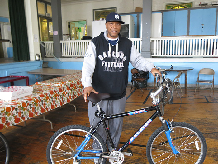 A participant shows his newly repaired bike at the Bike-Friendly Kingston free bike repair at the Repair Cafe.