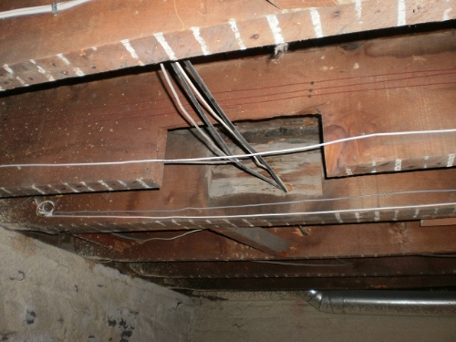 They probably didn't need to butcher that joist for the wiring!