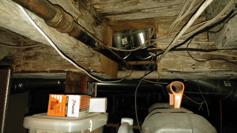 Looks like a heating contractor here took out a nice big piece of the main supporting beam in this century home in order to feed some gas lines