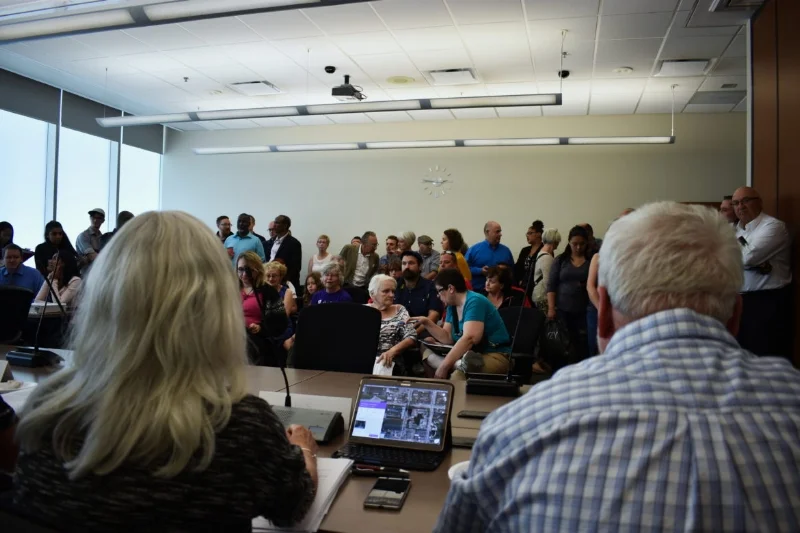 Getting a variance can involve a bunch of neighbors showing up to give you a piece of their minds - here's an example of unhappy residents showing up for the conversion of family units to singles in Hamilton. This doesn't happen all the time.