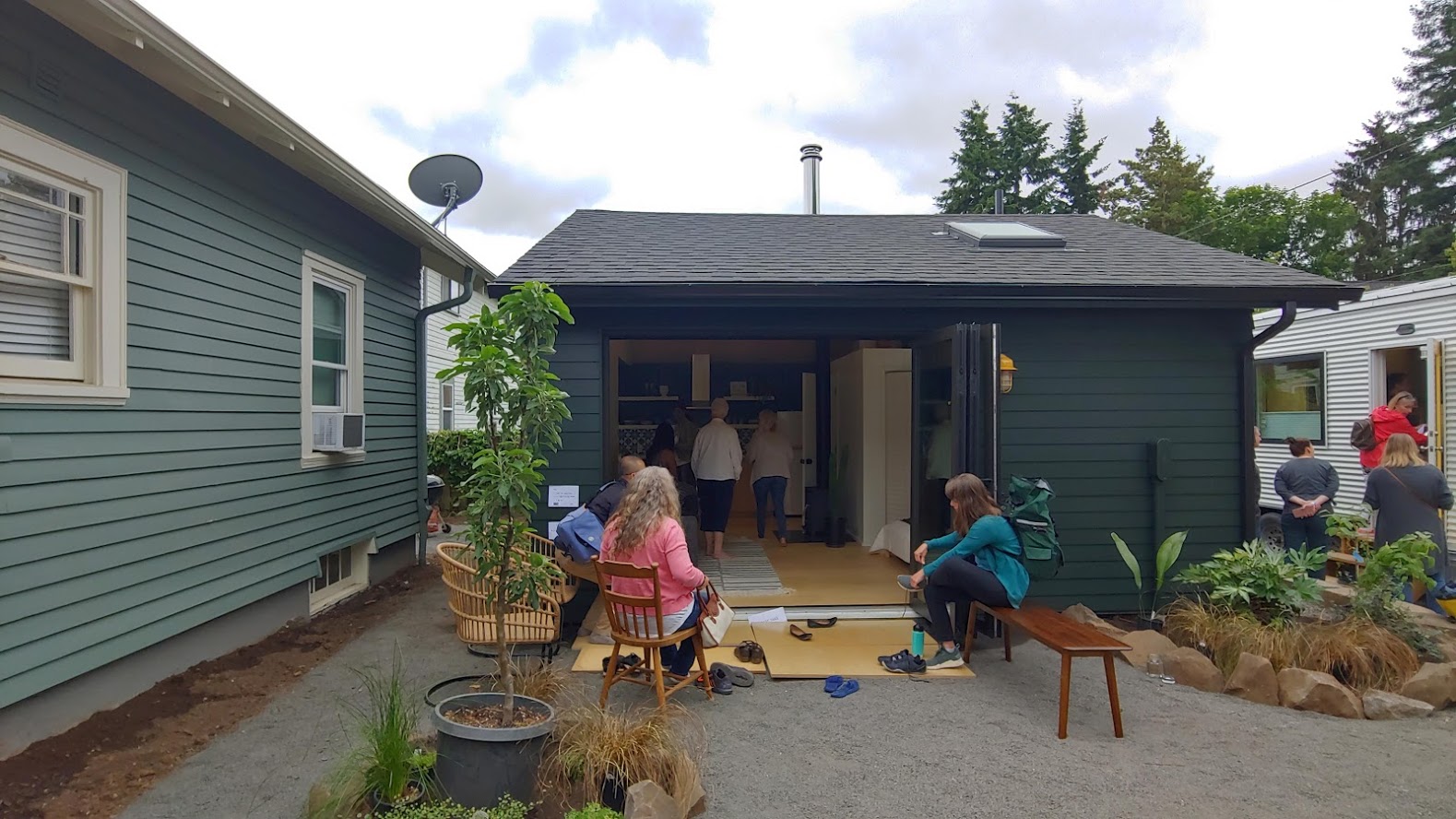 A different world in the backyard! There is a detached unit in the backyard (middle), and another tiny house on the right. 3 units in 1! Owner lives in the middle while renting out the main house. Tiny house is an Airbnb. Party central! Builder: Sprucebox Construction