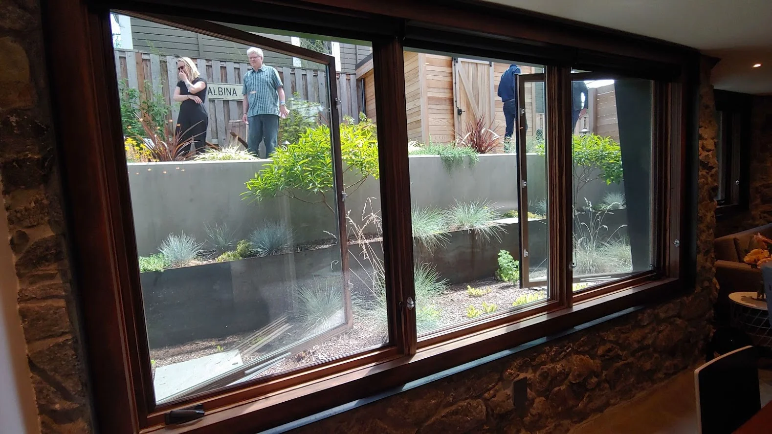 This basement window is approx. 8 feet wide x 4 feet high. With some expensive landscaping work outside. Not only does this meet escape and lighting needs, it also creates a space that feels nothing like a basement suite.