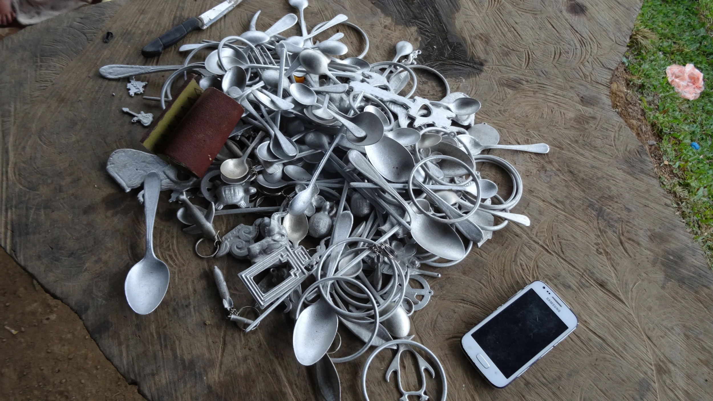 Local entrepreneurs make key chains and spoons from bomb scrap metal found in the area. 