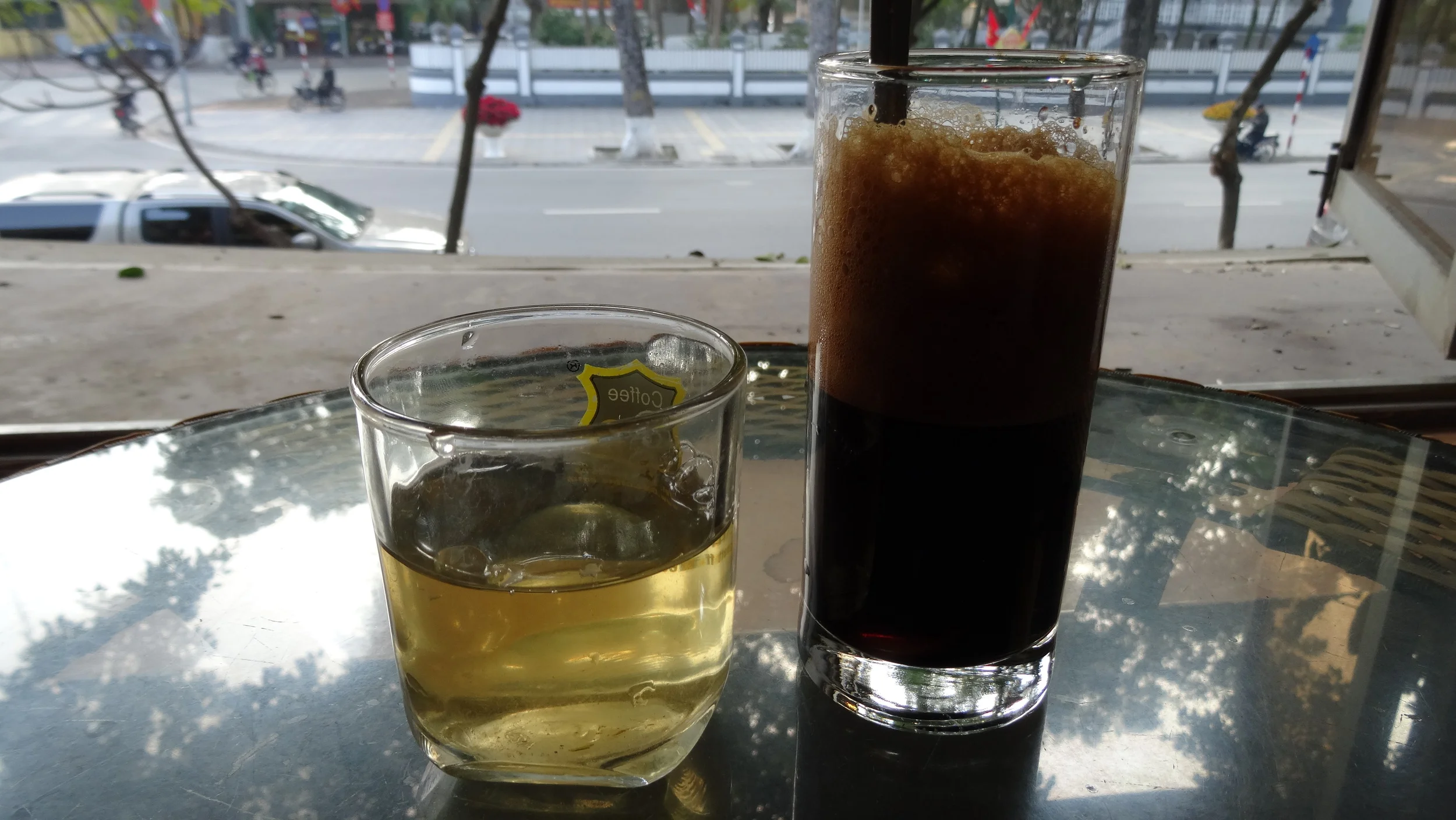 There maybe more Cafés in Hanoi than in Paris. The coffee in Vietnam is some of my favorite. It's slightly sweet and chocolatey. You can get it many different ways, but usually iced, either black ( cà phê phin ) or with sweetened condensed milk ( Cà phê sữa da ). Quick fact: Vietnam is the worlds second leading exporter of coffee. 