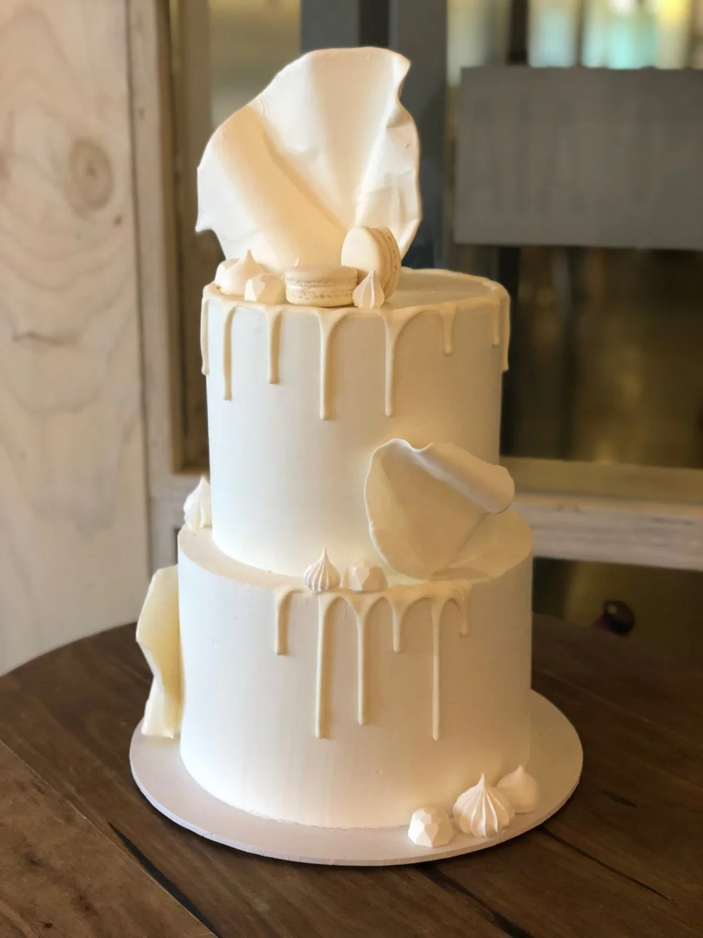 White Buttercream Cake with White Drip, Macarons, Chocolate Gems & Meringues