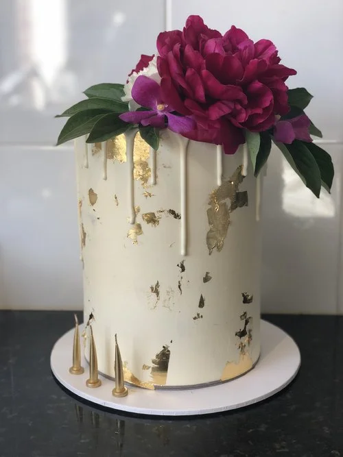 The Gold Leaf & White Drip Cake available to order now on our Online Bakeshop