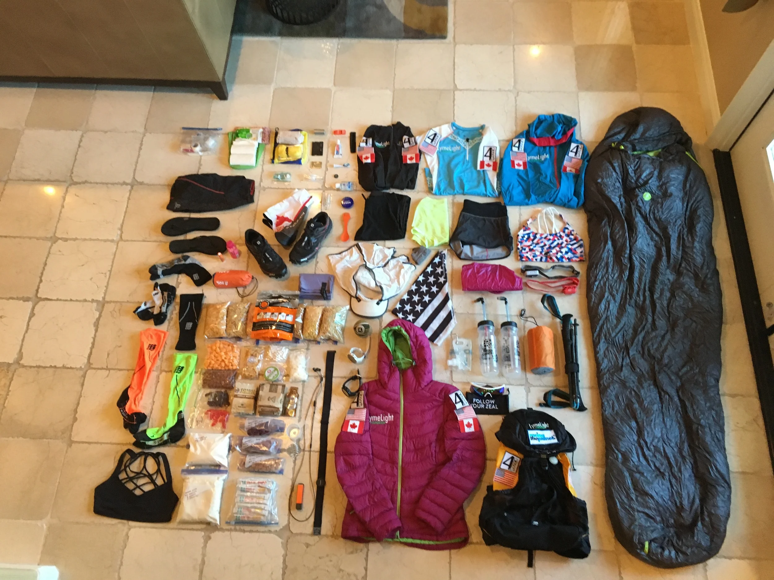 Image provided by Jax of all of the items that fit in her 18lb pack while she runs each event!