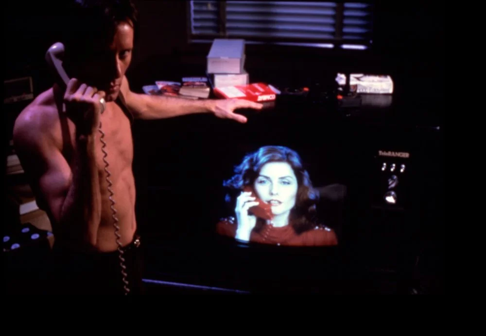videodrome-1983-002-james-woods-on-the-phone-debbie-harry-on-tv-bfi-00o-ap3.jpg