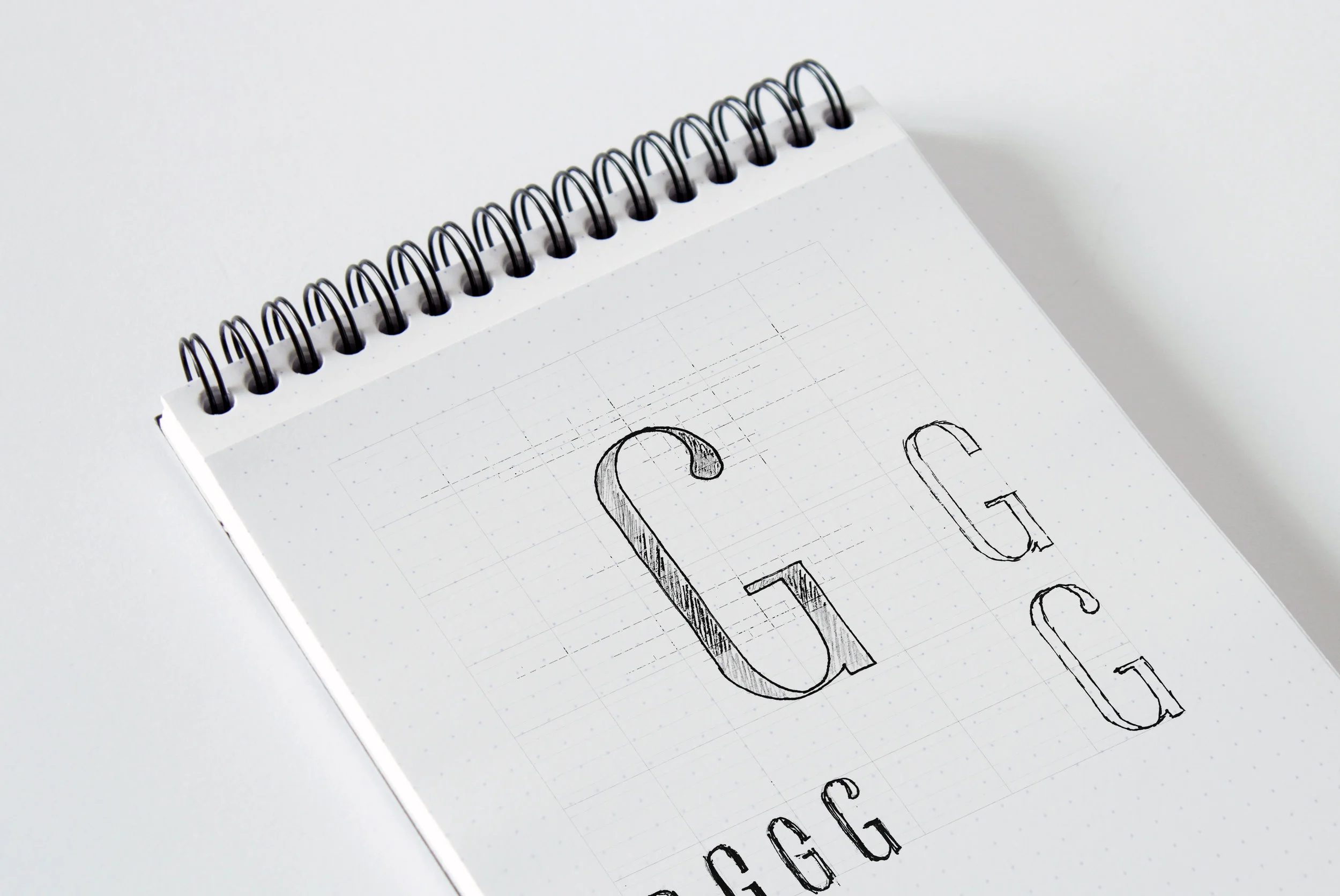 concept sketches of the custom typeface featuring the 'g' creation