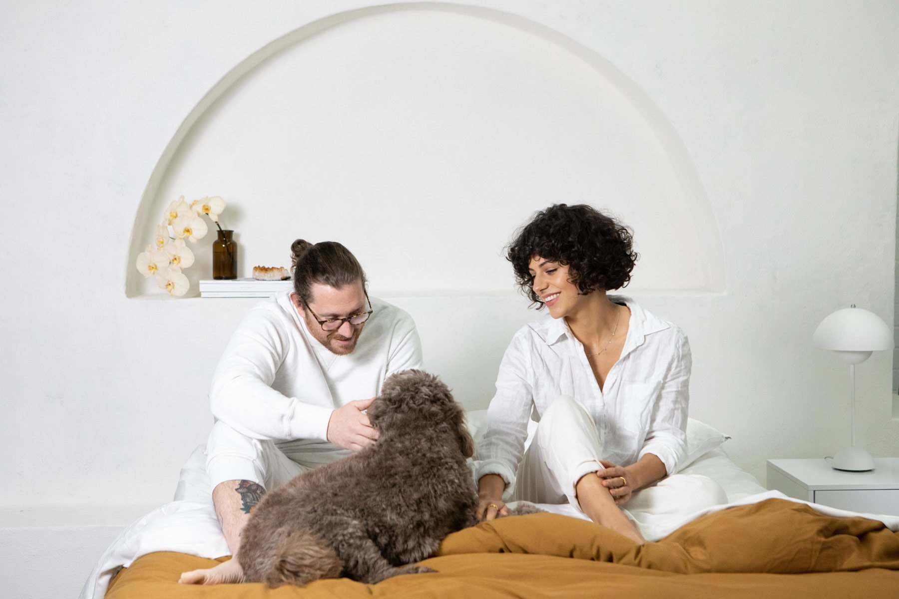 Shhh Silk Studio Photography Shoot, Silk Sheets lay on bed in stylised setting with a couple and dog