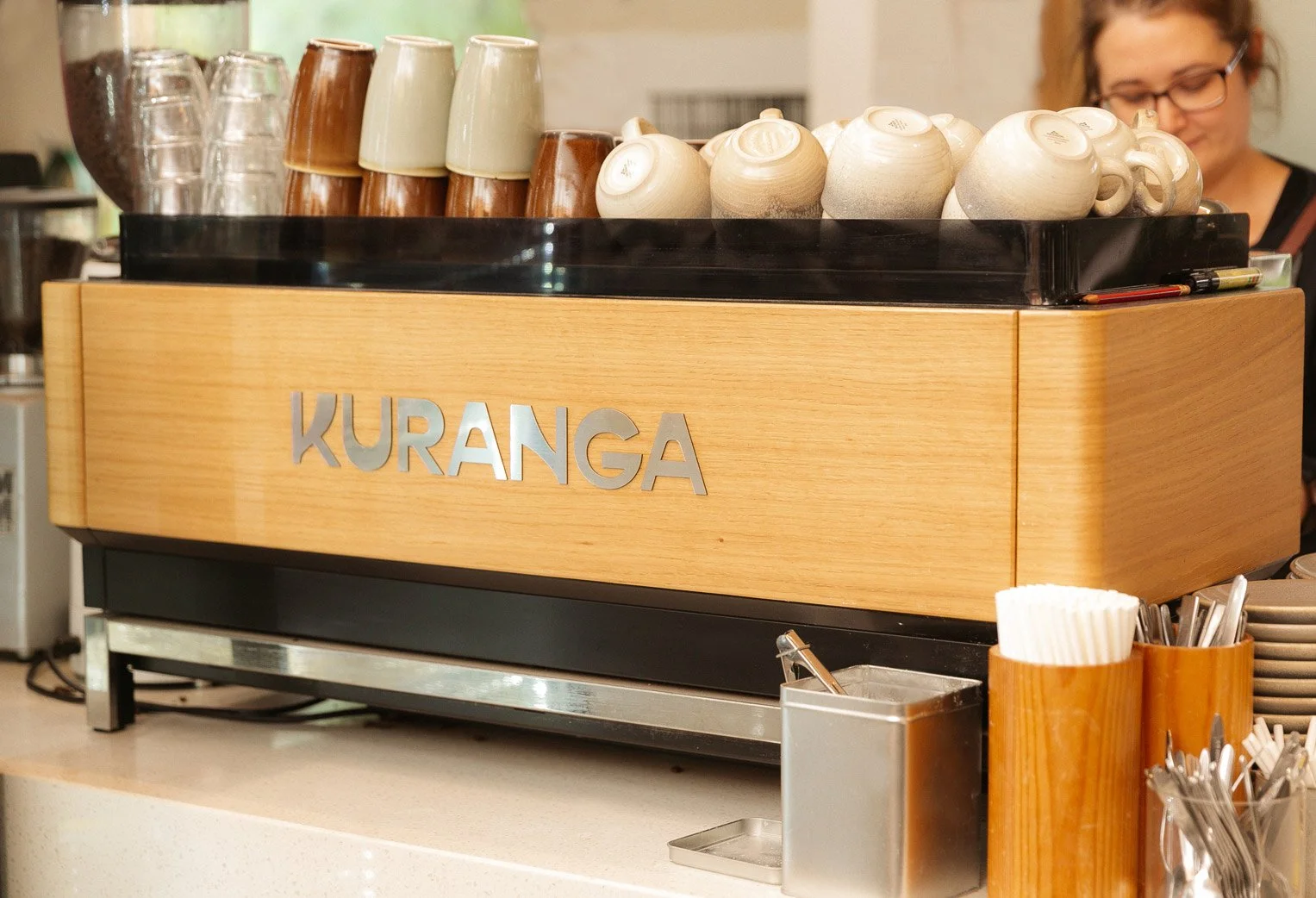 detail shot of Kuranga logo on coffee machine, silver cut typogaphy