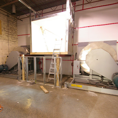 FROM WAREHOUSE TO WIND TUNNEL On this project, we took an empty warehouse space and converted it into a high-tech testing facility , complete with a wind tunnel and an air-conditioned data storage area.