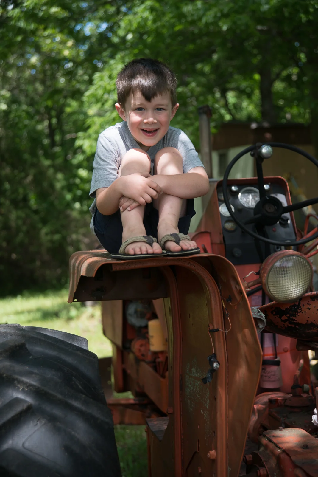 Aiden loves hanging out on GPa's tractor!