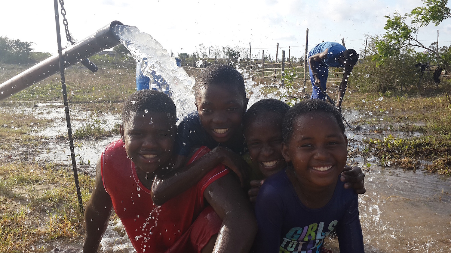 Children enjoy the novelty of pumped water for the first time