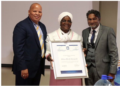 Ms Rebecca Pfarelo Ramugondo (centre) receiving an award for her outstanding contribution, commitment and support to communities struggling with water challenges from Mr Errol Gradwell (CEO EWSETA) (left), and Mr Dhesigen Naidoo (WRC) (right).