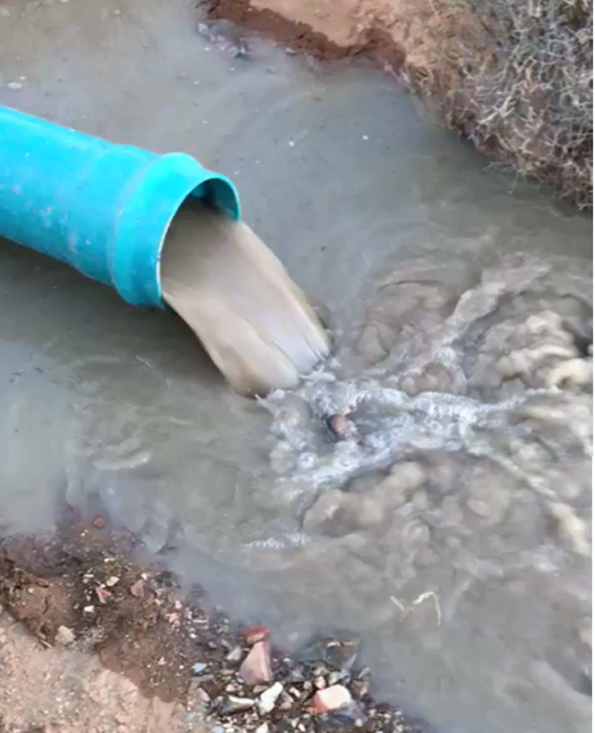 Air lifted groundwater flows through the pipe