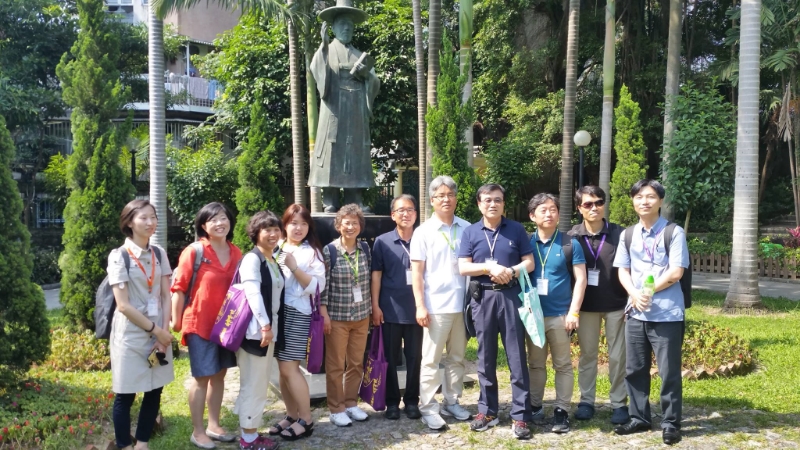 Korean participants stand under the statue of St. Taegeon Andrew Kim (photo by Chris Rice)