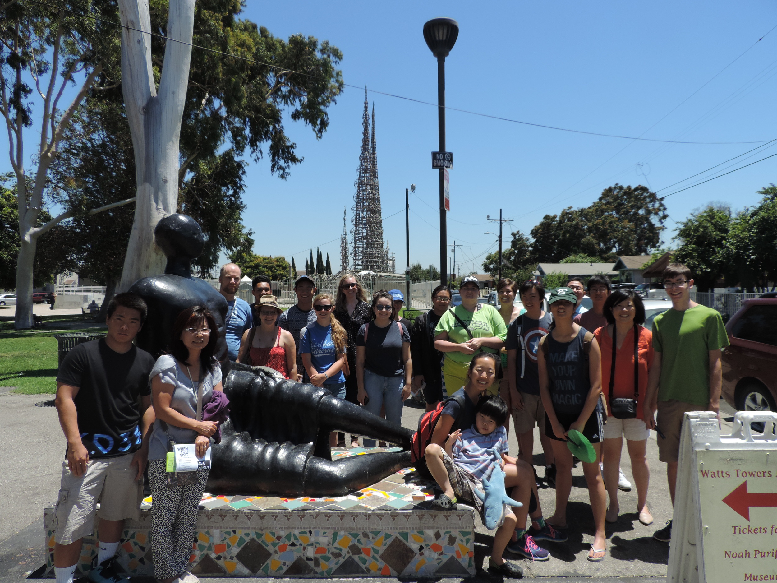 A group photo in front of the Watts Tower in South Central Los Angeles learning about the rich history of LA