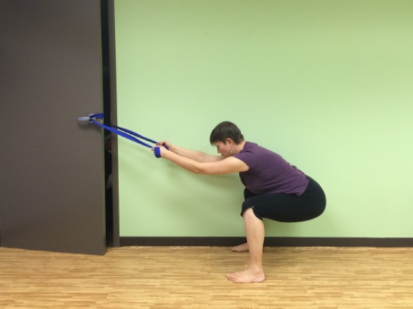 Strap Squat - wrap a yoga strap around a door knob and use it to help balance yourself as you keep your shins vertical in your squat, use this to lower down part way or all the way down into a full squat, be mindful not to bear down or hold your breath