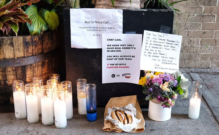 A memorial for Chef Carl Ruiz, which includes hot dogs, has been set up at La Cubana NYC.