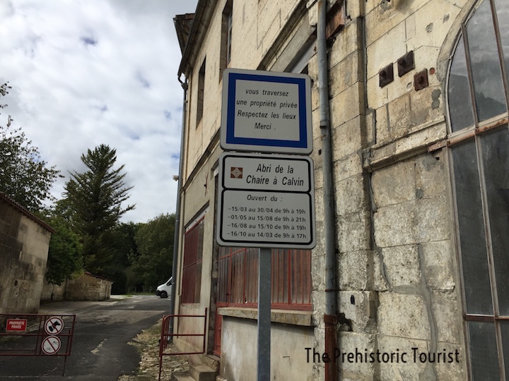 The entrance to La Chaire à Calvin. Walk through the metal gate to access the rock shelter.