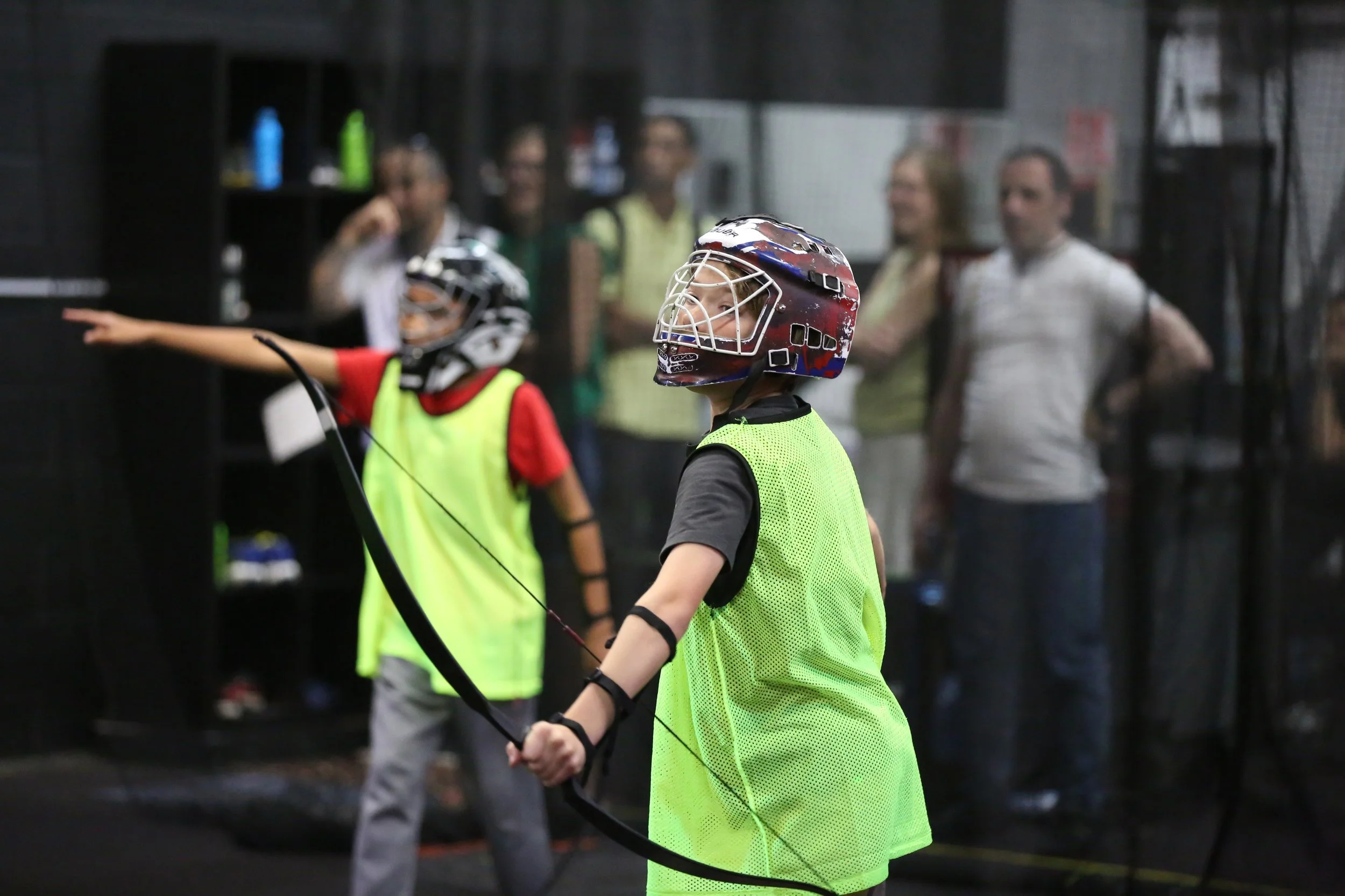 Kids and families playing combat archery in Toronto indoor arena