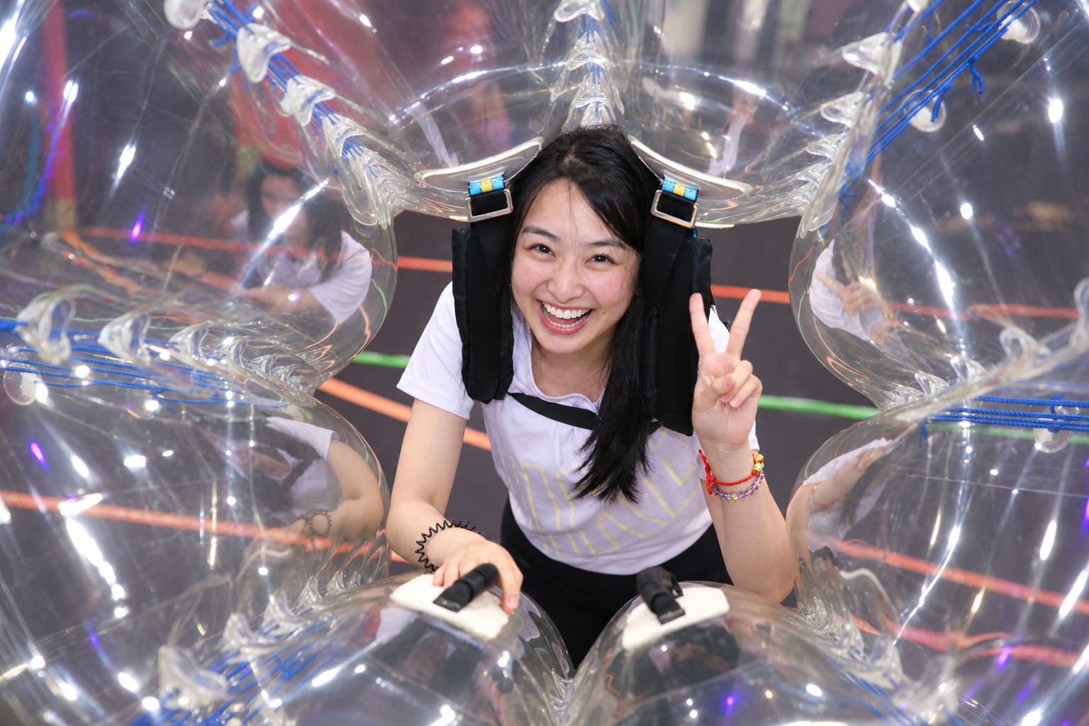Friend group playing bubble soccer games indoors in North York
