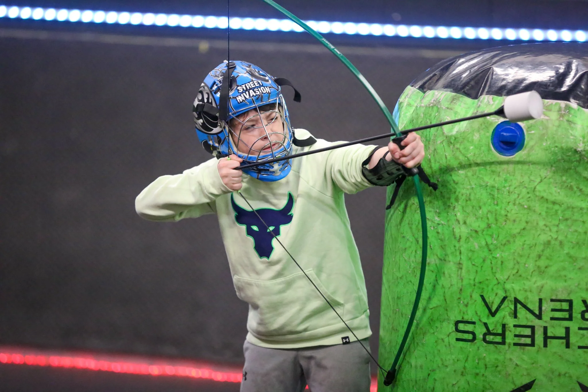 Kids playing indoor combat archery in North York this November