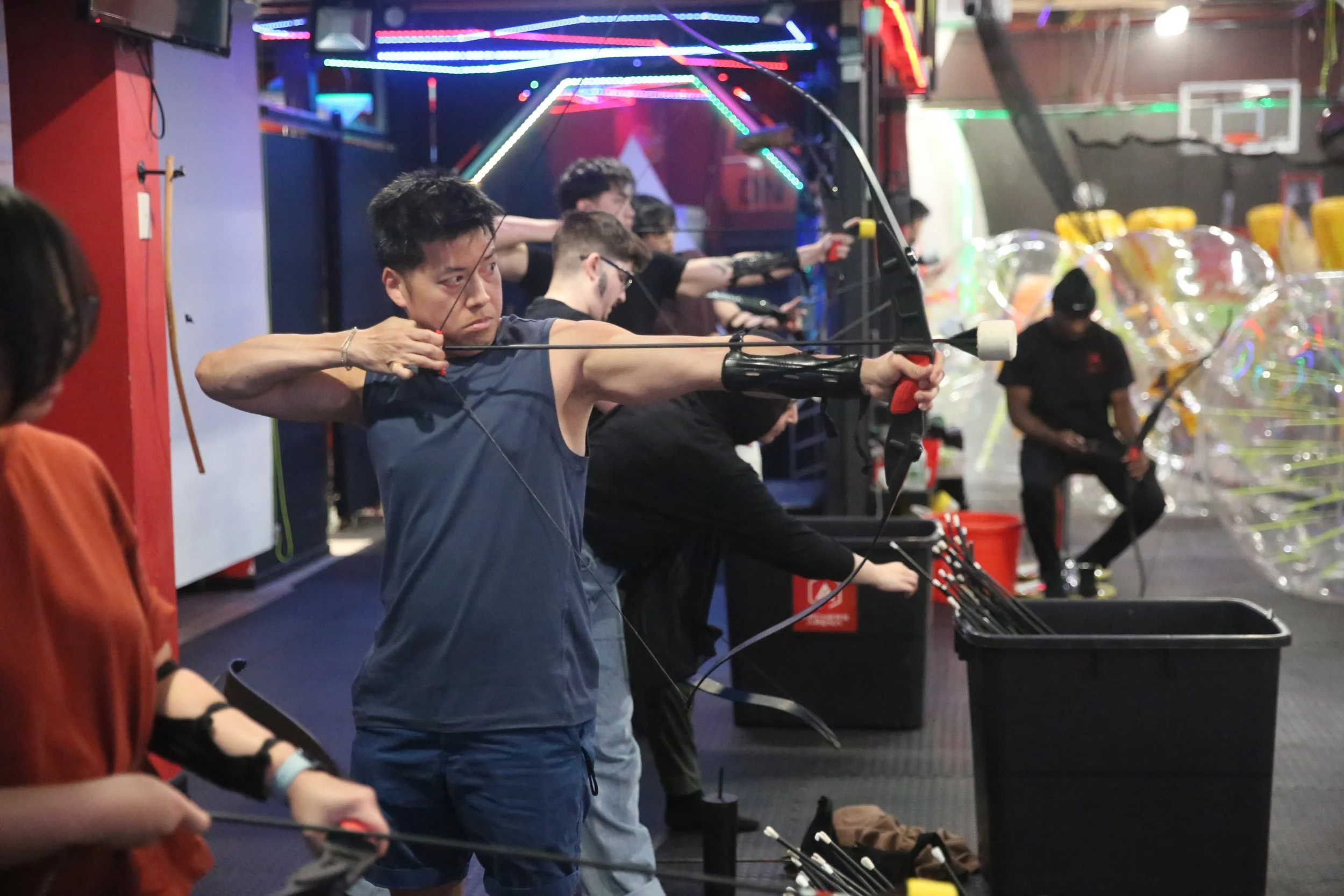Adult learning archery basics in indoor range Toronto