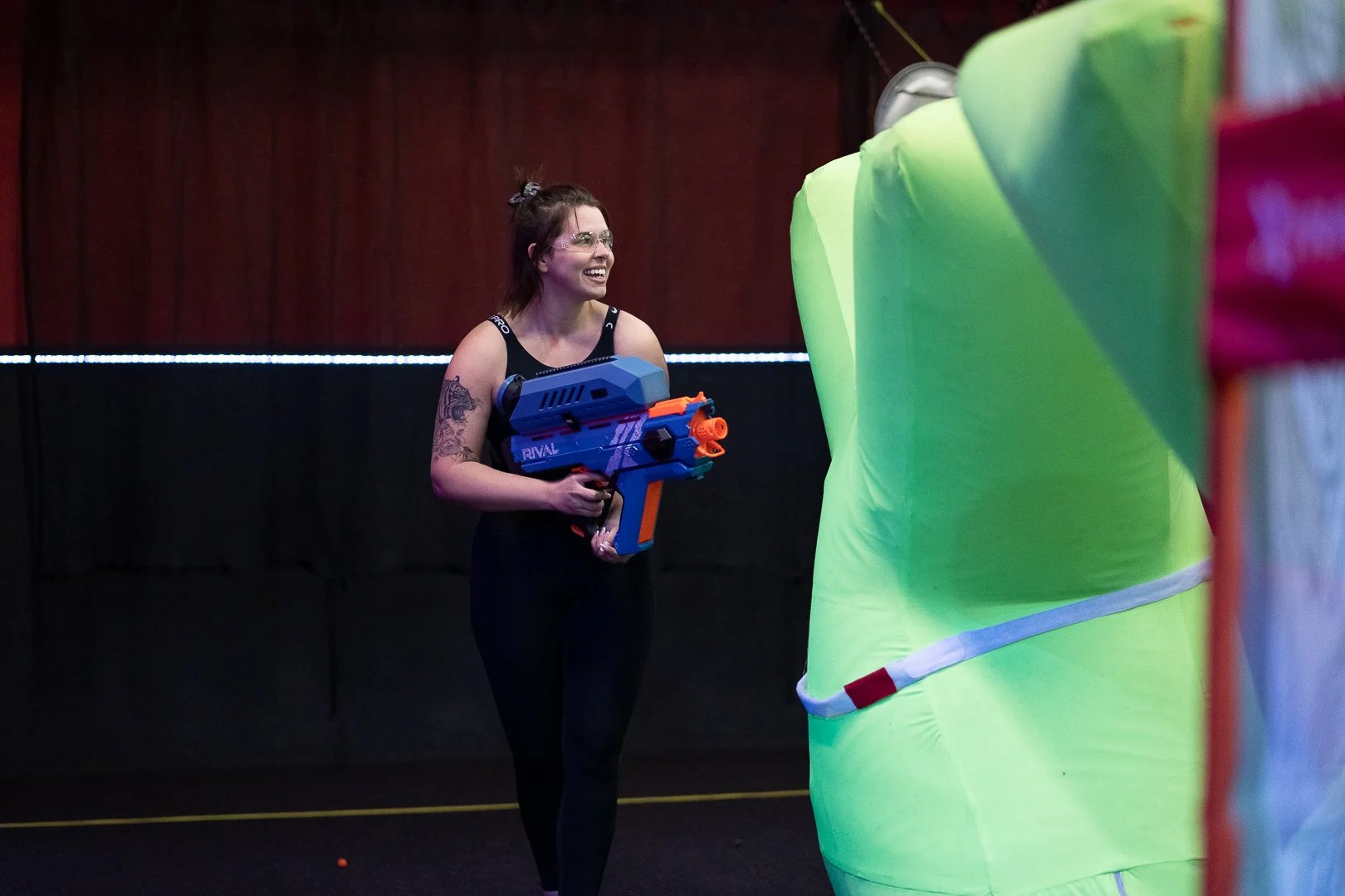 Group of adults enjoying Nerf blaster battle indoor activity Toronto