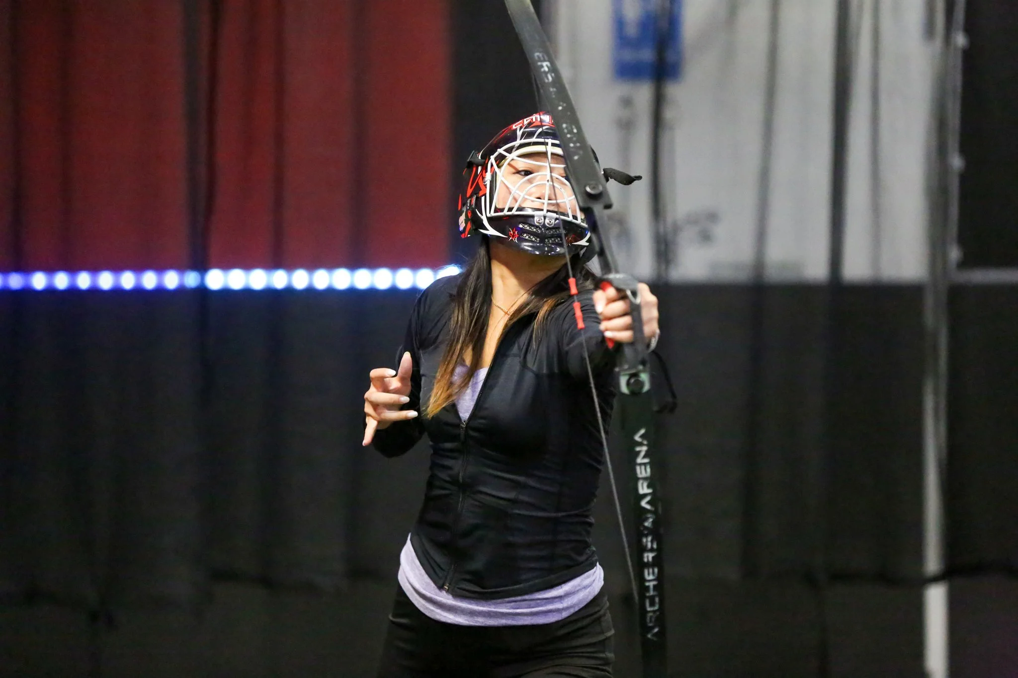Group playing Combat Archery in an indoor Toronto arena