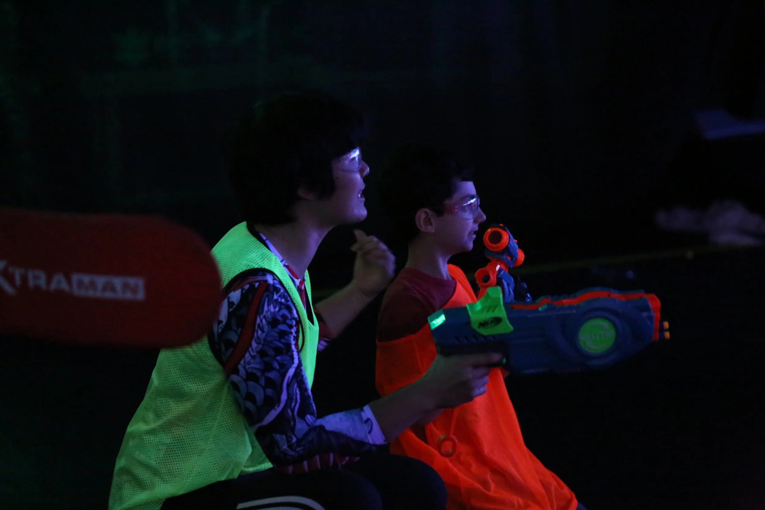 Family enjoying Nerf blaster battle indoor activity in Toronto rain or shine