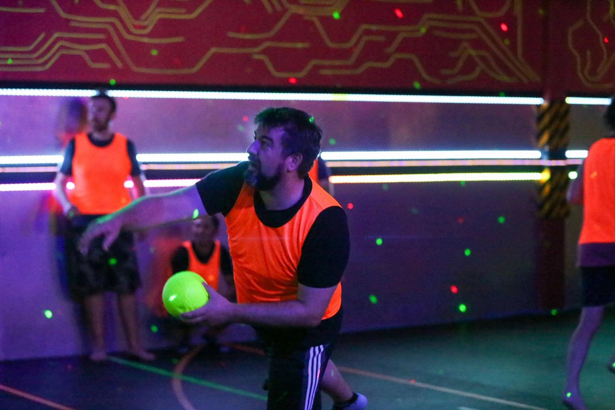 Group playing Blacklight Dodgeball during a unique indoor activity in Toronto