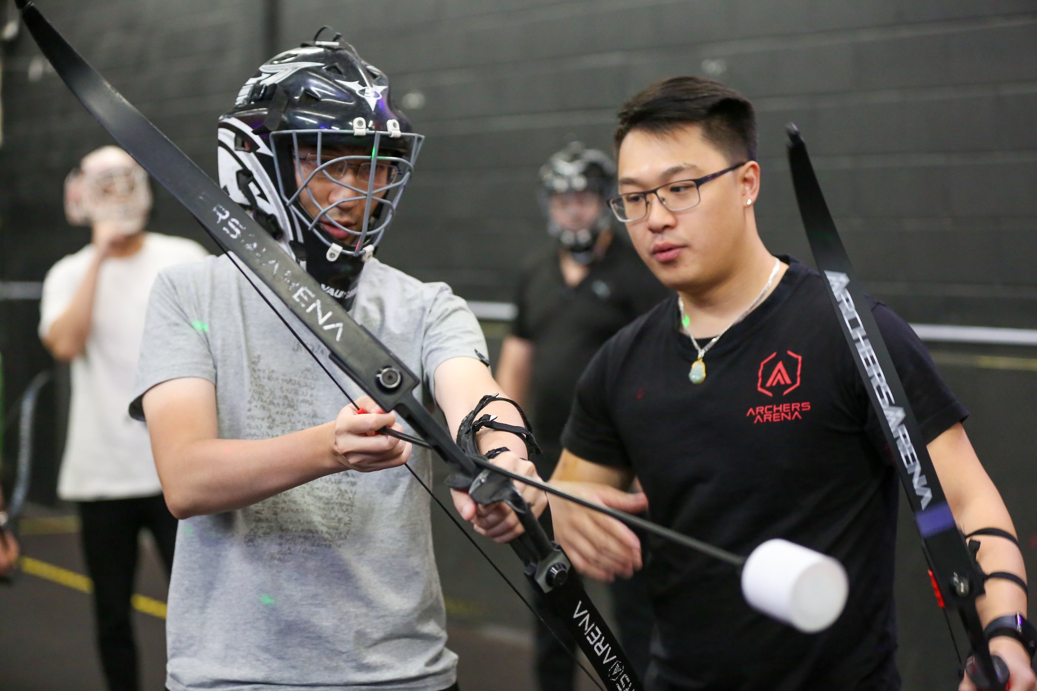 Instructor teaching a beginner archery lesson in Toronto at Archers Arena