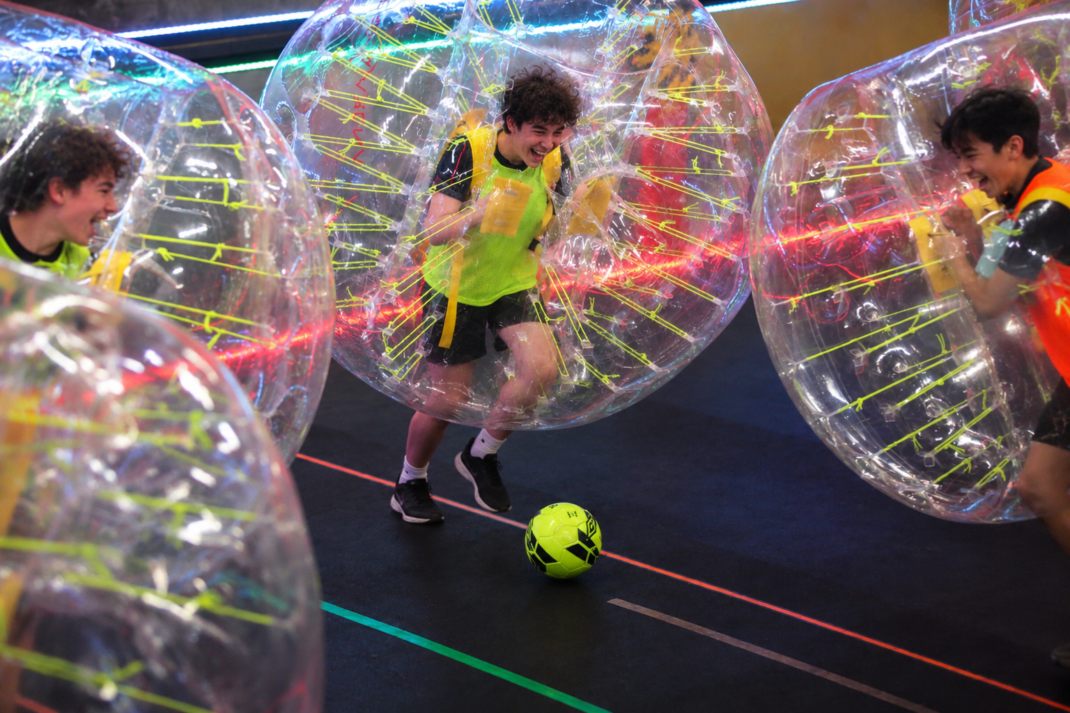 Teenagers enjoying Bubble Soccer at an indoor birthday party in Toronto.