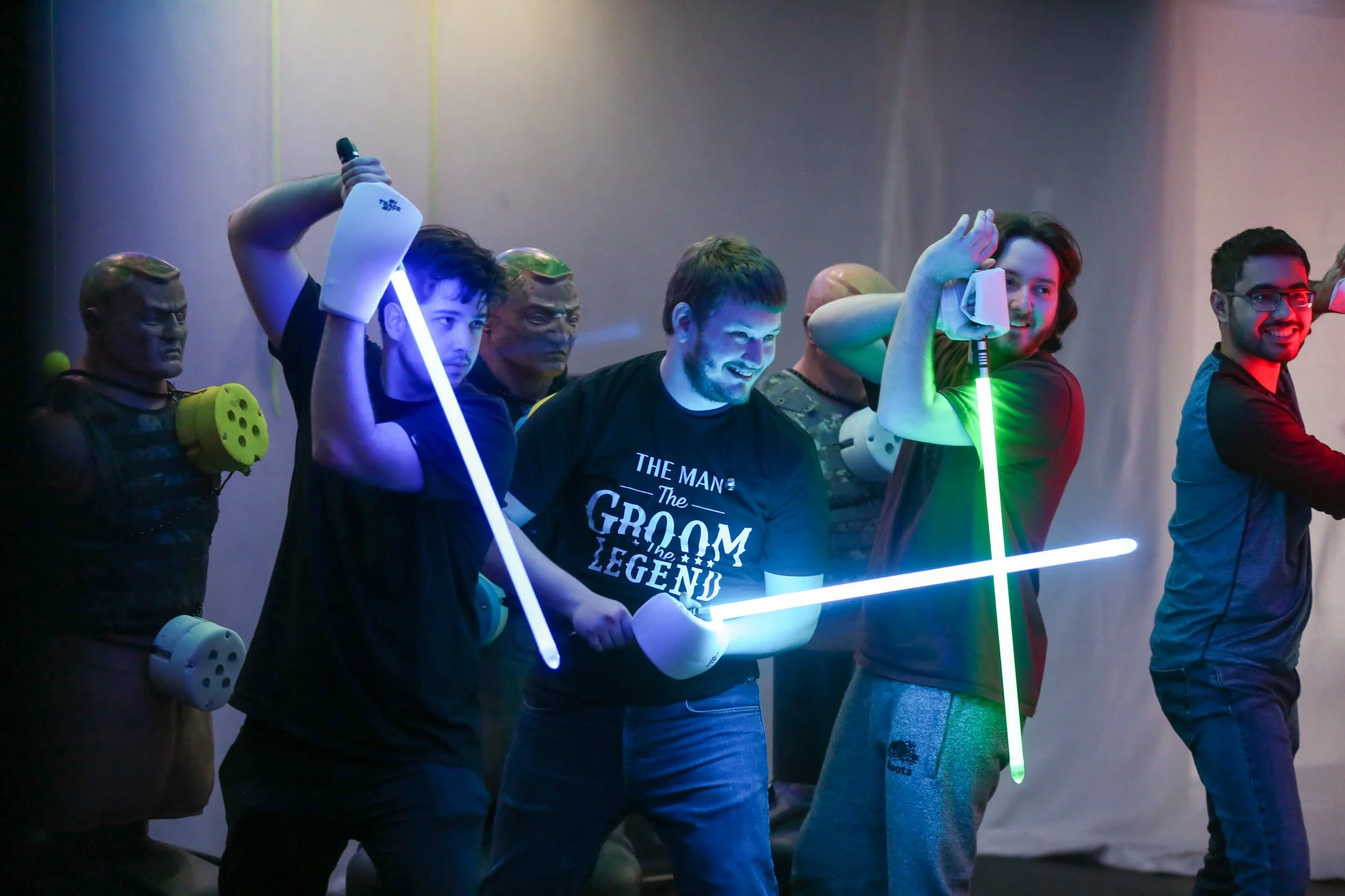Group posing with glowing lightsabers before a duel at Archers Arena in Toronto