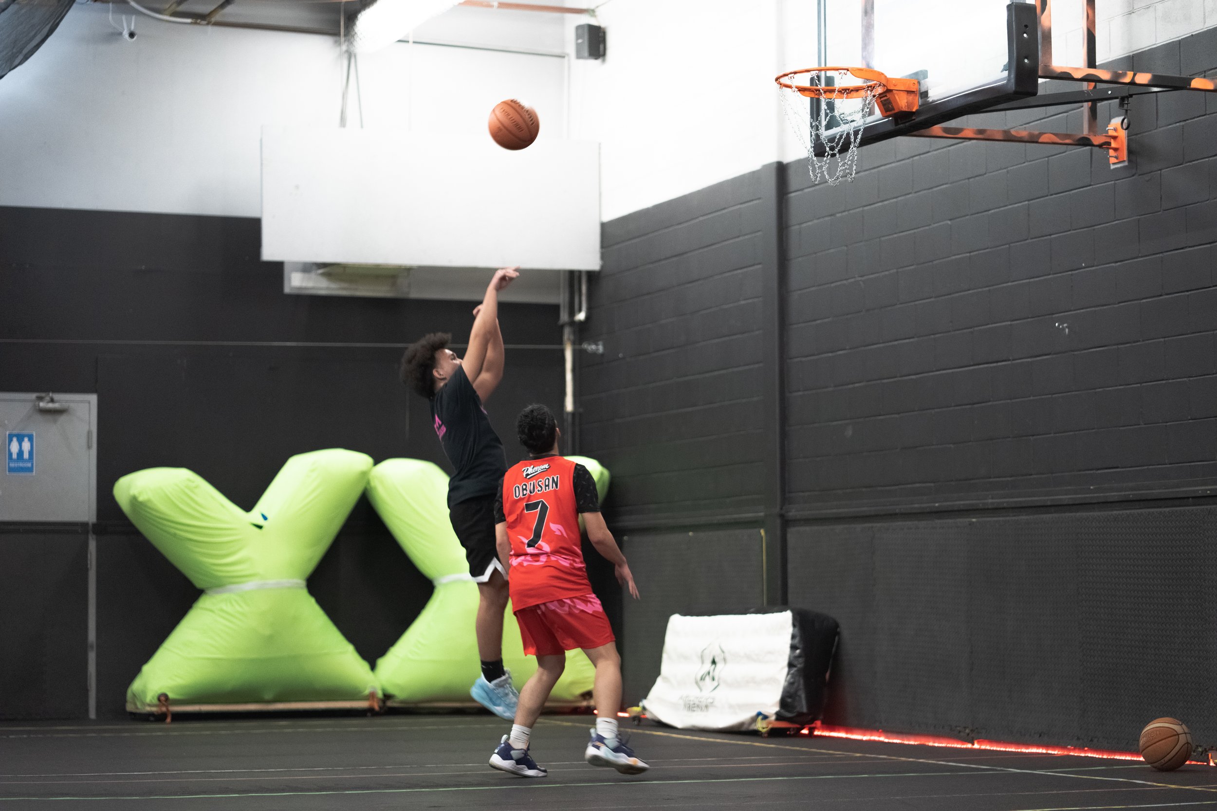 group playing basketball in indoor air conditioned court Toronto clean indoor basketball court available for rent in Toronto