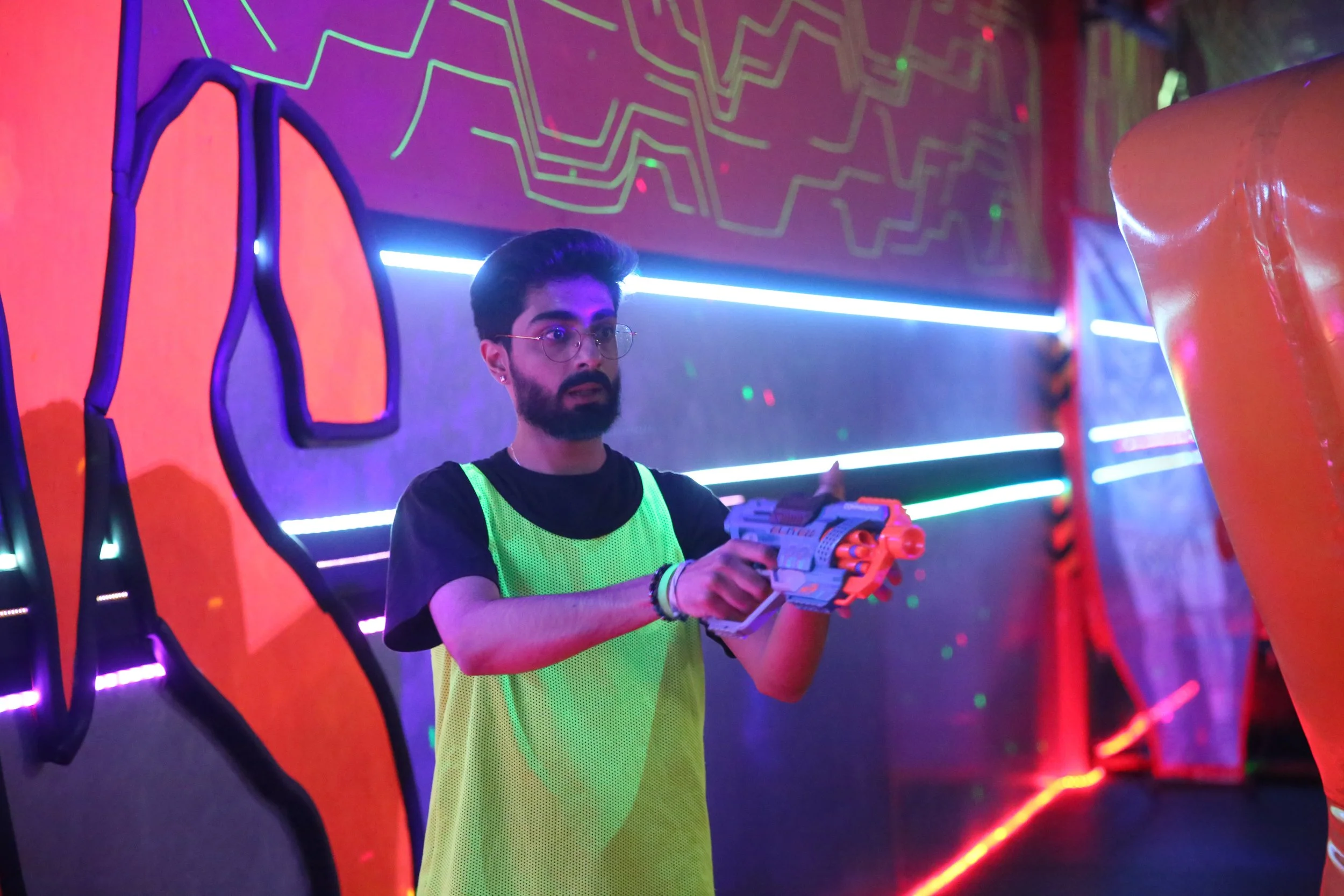 group playing nerf blaster battle indoor arena fast paced action