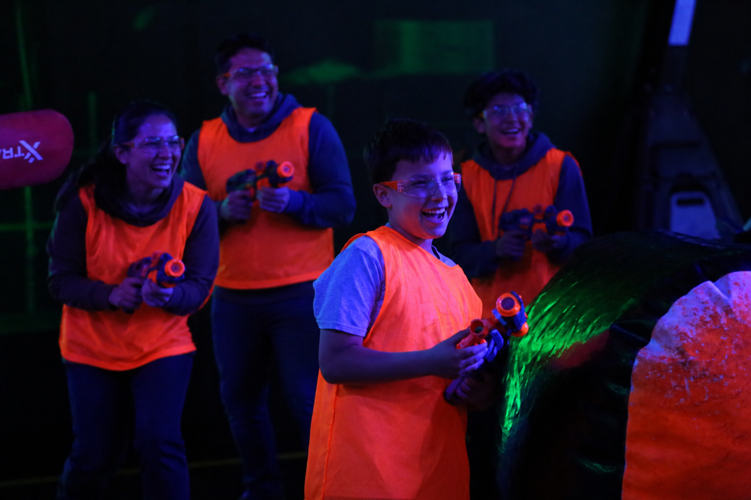 Family enjoying indoor activities together at Archers Arena in North York