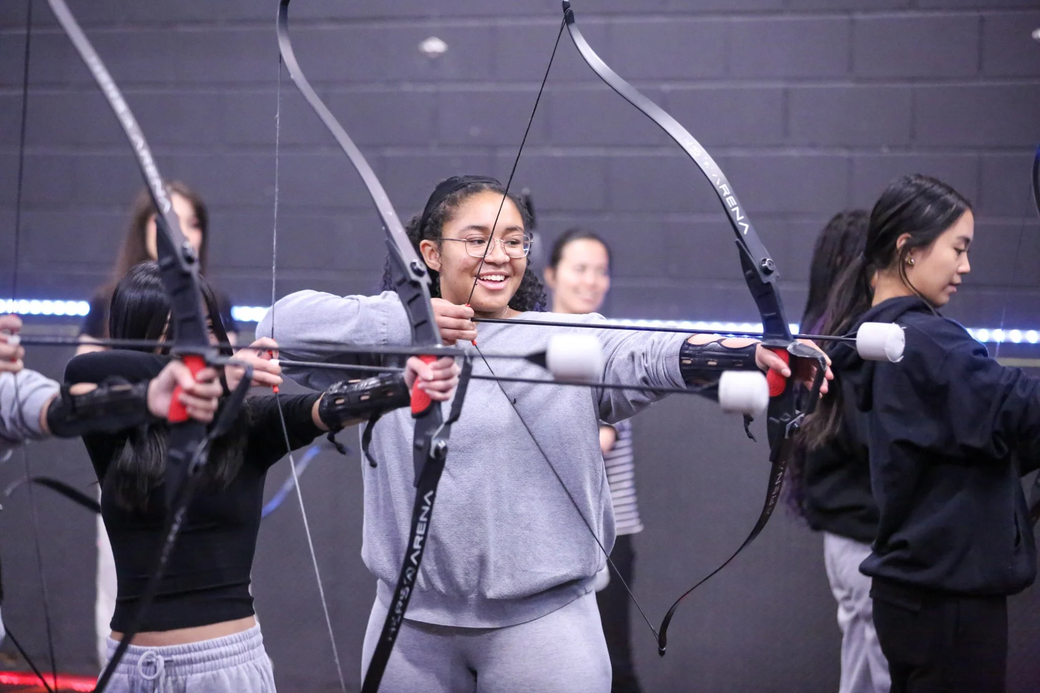 First-time archers enjoying beginner archery lessons at Archers Arena in Toronto