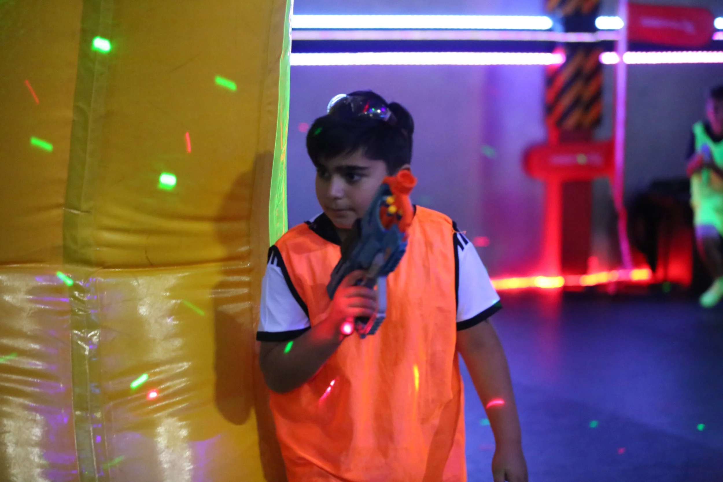 Children participating in Nerf blaster wars at Toronto summer camp