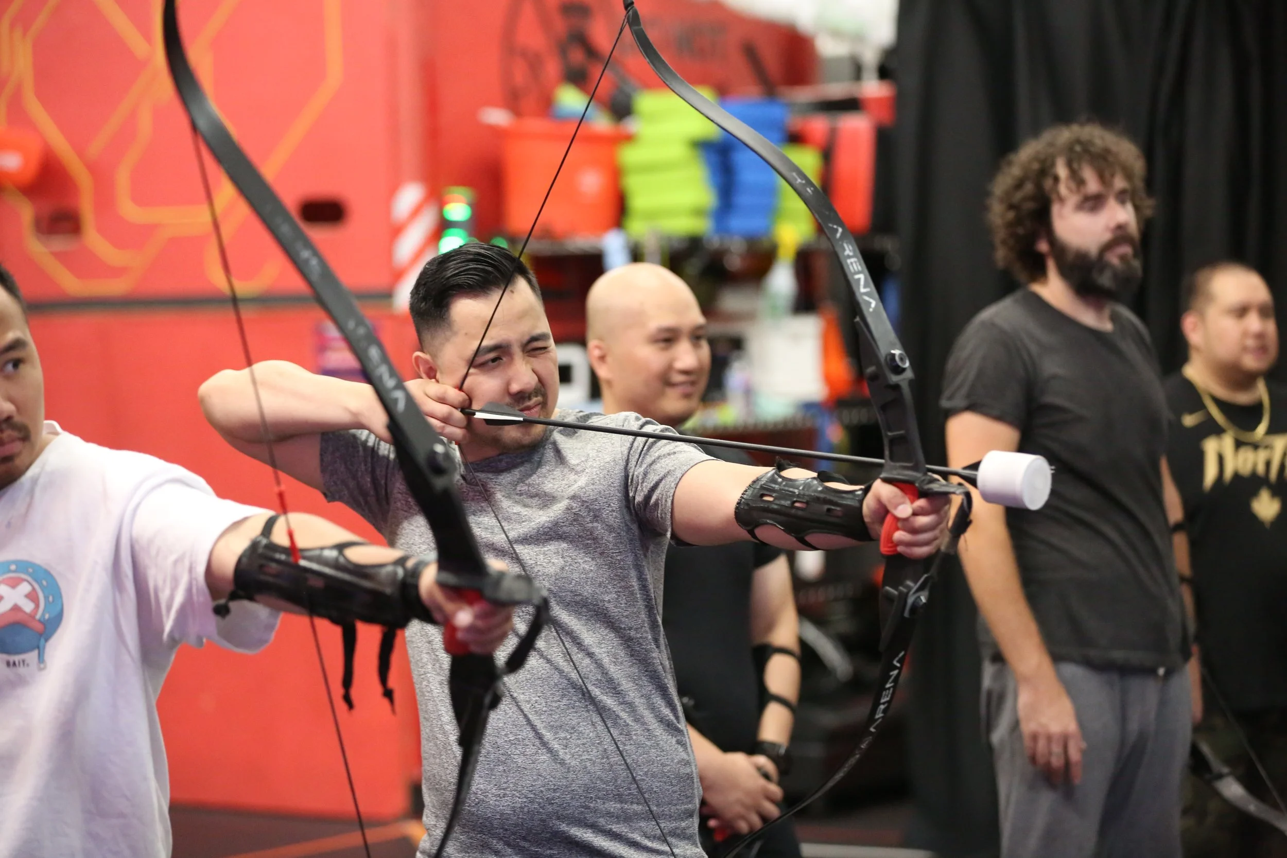 Coworkers playing Combat Archery at a corporate event in Toronto