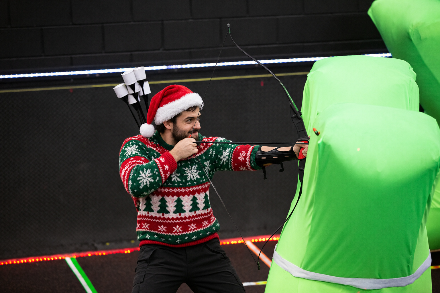 Office team strategizing during a holiday team building game at Archers Arena in Toronto