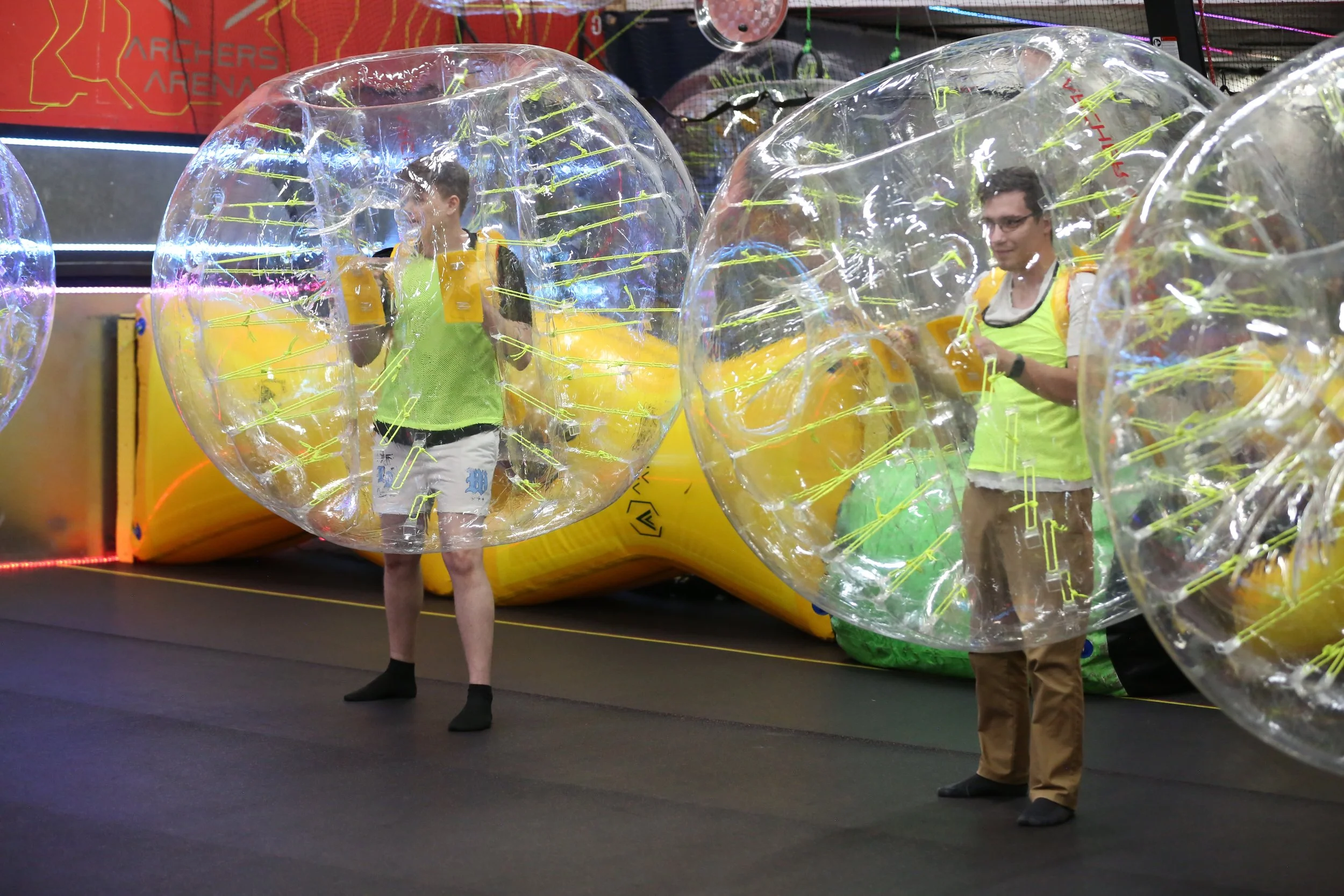 Corporate group laughing while playing Bubble Soccer at a Toronto team-building event